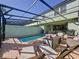 Private screened pool and patio area with lounge chairs at 4626 Terrasonesta Dr, Davenport, FL 33837