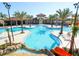 Large resort pool with water slide and surrounding lounge area at 4626 Terrasonesta Dr, Davenport, FL 33837