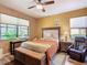 Bedroom with king-size bed and ceiling fan at 509 Millifiora Ln, Kissimmee, FL 34759