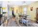 Open concept dining area showcasing a wooden table and soft yellow walls at 509 Millifiora Ln, Kissimmee, FL 34759