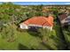 House with orange tile roof and screened patio overlooking green space at 542 Viterra Ct, Kissimmee, FL 34759