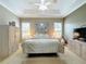 Comfortable guest bedroom with a queen-size bed and lots of natural light at 542 Viterra Ct, Kissimmee, FL 34759