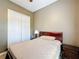 Guest bedroom with double door closet and wood furniture at 542 Viterra Ct, Kissimmee, FL 34759