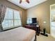 Charming bedroom with a full-size bed, window seating, and access to a patio at 542 Viterra Ct, Kissimmee, FL 34759