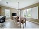 Spacious dining area with large windows and rustic table at 542 Viterra Ct, Kissimmee, FL 34759