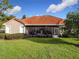 Single-story home with a terracotta tile roof and well-maintained lawn at 542 Viterra Ct, Kissimmee, FL 34759