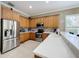 Modern kitchen with stainless steel appliances and light oak cabinetry at 542 Viterra Ct, Kissimmee, FL 34759