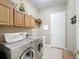Convenient laundry room with washer, dryer, and extra storage at 542 Viterra Ct, Kissimmee, FL 34759