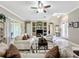 Spacious living area with tile floors, comfy sofas, and built-in shelving at 542 Viterra Ct, Kissimmee, FL 34759
