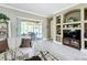 Spacious living room featuring built-in shelving and access to a relaxing outdoor patio at 542 Viterra Ct, Kissimmee, FL 34759