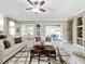 Spacious living area with tile floors, comfy sofas, and built-in shelving at 542 Viterra Ct, Kissimmee, FL 34759