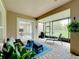 Serene screened patio with lounge chairs and access to the backyard at 542 Viterra Ct, Kissimmee, FL 34759
