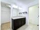 Double vanity bathroom with dark cabinets and a walk-in closet at 627 Lucerne Blvd, Winter Haven, FL 33881