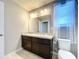 Double vanity bathroom with dark brown cabinets and granite countertop at 627 Lucerne Blvd, Winter Haven, FL 33881