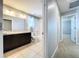 Bathroom with dark brown vanity, tile floor, and bathtub at 627 Lucerne Blvd, Winter Haven, FL 33881