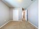 Bedroom with carpet, closet, and hallway access at 627 Lucerne Blvd, Winter Haven, FL 33881