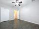 Simple bedroom with dark flooring and a ceiling fan at 627 Lucerne Blvd, Winter Haven, FL 33881