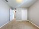 Bedroom with carpet, closet, and hallway access at 627 Lucerne Blvd, Winter Haven, FL 33881