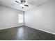 Simple bedroom with dark flooring and a ceiling fan at 627 Lucerne Blvd, Winter Haven, FL 33881