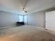 Spacious bedroom with carpeted floor, ceiling fan, and window at 627 Lucerne Blvd, Winter Haven, FL 33881