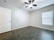Simple bedroom with dark flooring and a ceiling fan at 627 Lucerne Blvd, Winter Haven, FL 33881