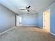 Primary bedroom with ceiling fan and access to bathroom at 627 Lucerne Blvd, Winter Haven, FL 33881