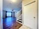 Entryway with staircase, wood floors, and view into living room at 627 Lucerne Blvd, Winter Haven, FL 33881