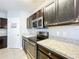 Modern kitchen with dark cabinets and granite countertops at 627 Lucerne Blvd, Winter Haven, FL 33881