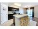 Kitchen features dark wood cabinets and an island with seating at 627 Lucerne Blvd, Winter Haven, FL 33881