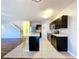 Modern kitchen with dark cabinetry, stainless steel appliances, and an island at 627 Lucerne Blvd, Winter Haven, FL 33881
