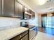 Modern kitchen with dark cabinets and granite countertops at 627 Lucerne Blvd, Winter Haven, FL 33881
