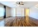 Spacious living room with wood floors, built-in shelves, and ceiling fan at 627 Lucerne Blvd, Winter Haven, FL 33881