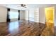 Bright living room with hardwood floors, built-in shelving, and a view of a bathroom at 627 Lucerne Blvd, Winter Haven, FL 33881