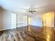 Spacious living room with wood floors, built-in shelves, and ceiling fan at 627 Lucerne Blvd, Winter Haven, FL 33881