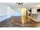 Open living space with hardwood floors, kitchen, and staircase at 627 Lucerne Blvd, Winter Haven, FL 33881