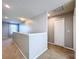 Upstairs hallway with neutral walls, carpet and door to bedroom at 627 Lucerne Blvd, Winter Haven, FL 33881