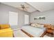 King-size bed, yellow chair, and large windows in this bright bedroom at 720 Siena Palm Dr # 202, Celebration, FL 34747
