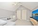 Spacious bonus room with L-shaped sofa, large TV, and ample closet space at 720 Siena Palm Dr # 202, Celebration, FL 34747