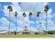 Community clubhouse with a windmill and palm trees at 720 Siena Palm Dr # 202, Celebration, FL 34747