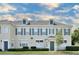 Two-story townhome with gray shutters and a neutral color scheme at 720 Siena Palm Dr # 202, Celebration, FL 34747