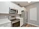 Modern kitchen with white cabinets and stainless steel appliances at 720 Siena Palm Dr # 202, Celebration, FL 34747