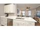 Modern kitchen with white cabinets and stainless steel appliances at 720 Siena Palm Dr # 202, Celebration, FL 34747