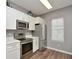 Modern kitchen with white cabinets and stainless steel appliances at 720 Siena Palm Dr # 202, Celebration, FL 34747