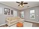 Bright living room with comfy sectional sofa and ceiling fan at 720 Siena Palm Dr # 202, Celebration, FL 34747