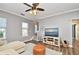 Relaxing living room with TV, sectional sofa, and hardwood floors at 720 Siena Palm Dr # 202, Celebration, FL 34747