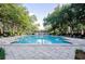 Community pool with lounge chairs and lush landscaping at 720 Siena Palm Dr # 202, Celebration, FL 34747