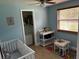 Bedroom with crib, changing table, and closet at 7311 Canal Dr, Sanford, FL 32771