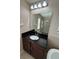 Bathroom with granite vanity, large mirror, and shower at 9107 Reflection Pointe Dr, Windermere, FL 34786