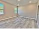 Spacious bedroom with two windows and wood-look floors at 1341 East Pkwy, Deland, FL 32724