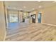 Open concept kitchen with island, stainless steel appliances, and light wood flooring at 1341 East Pkwy, Deland, FL 32724